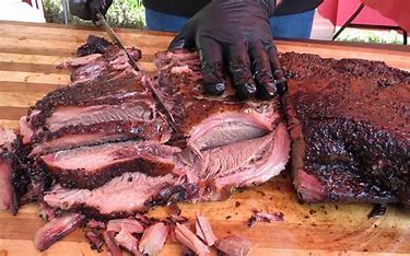 Pitmaster slicing freshly smoked brisket